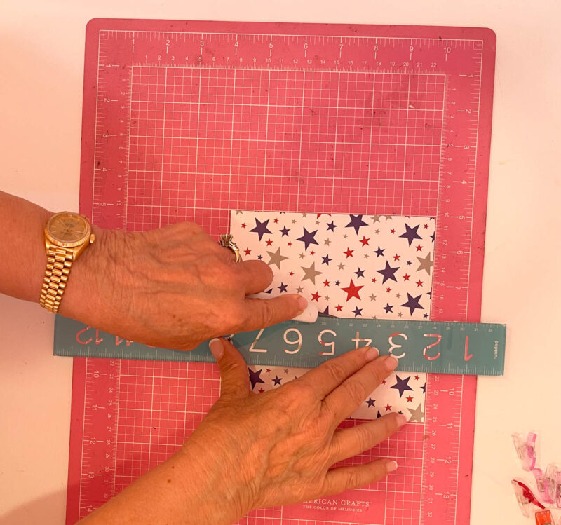 cutting 4th of July paper in half with an exacto knife