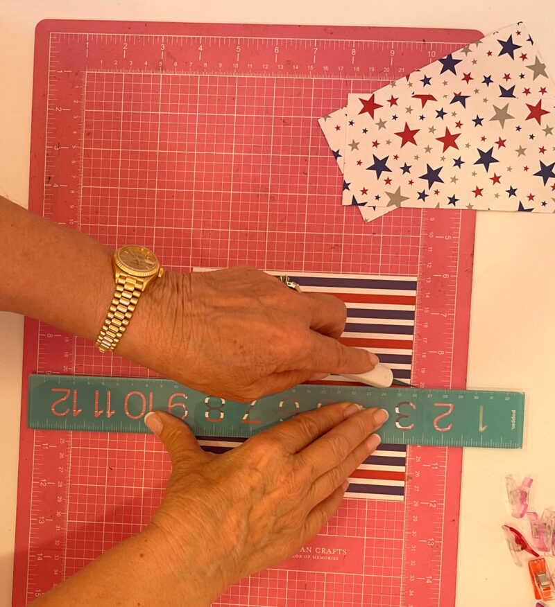 cutting 4th of July paper in half with an exacto knife