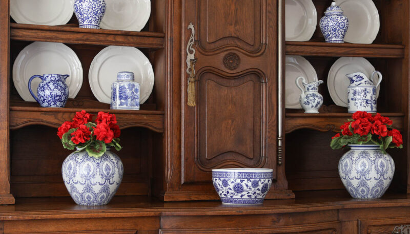 chinoiserie vases filled with faux red geraniums
