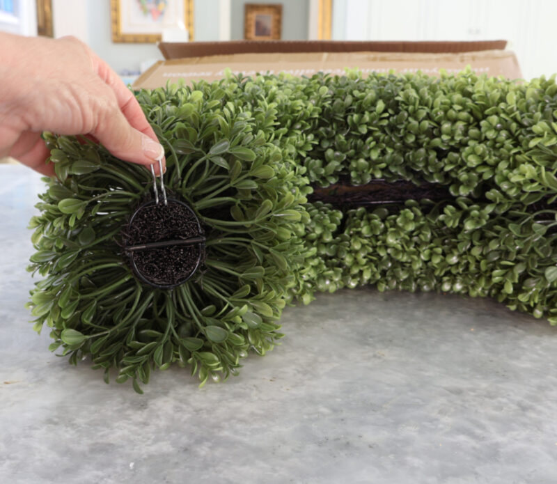 faux boxwood wreath folded showing clip