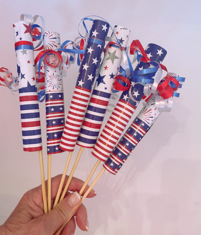 hand holding 4th of July firecrackers