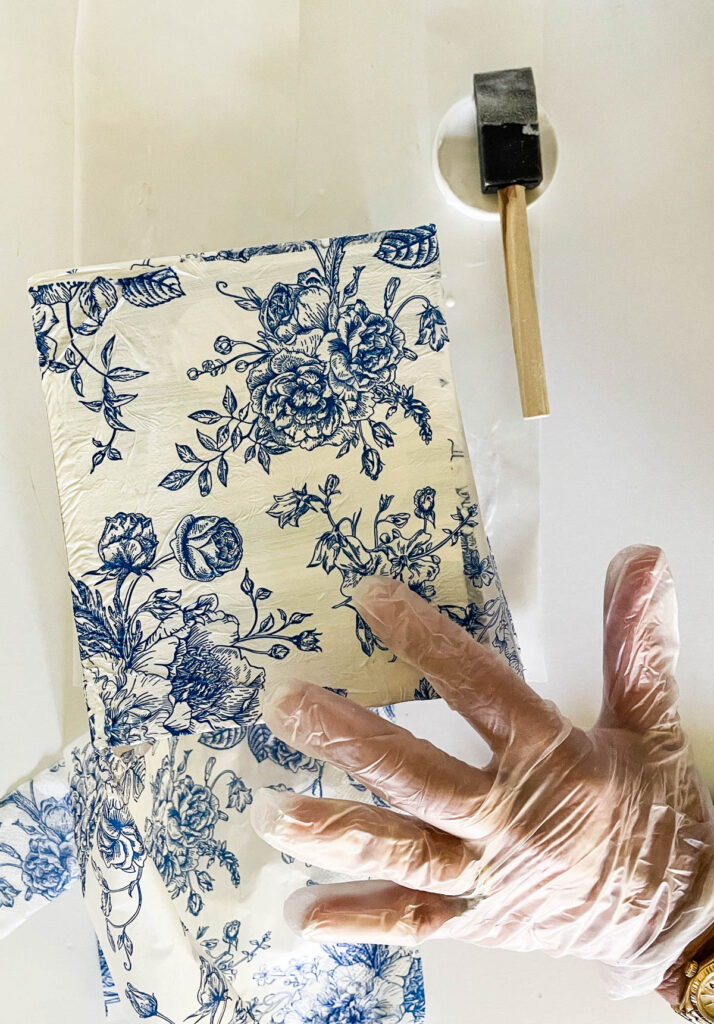 smoothing down deoupage paper