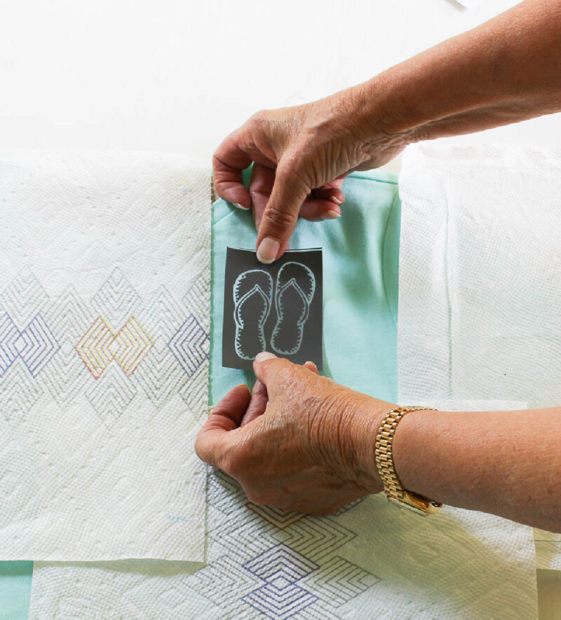 placing flip-flop stencil on t-shirt