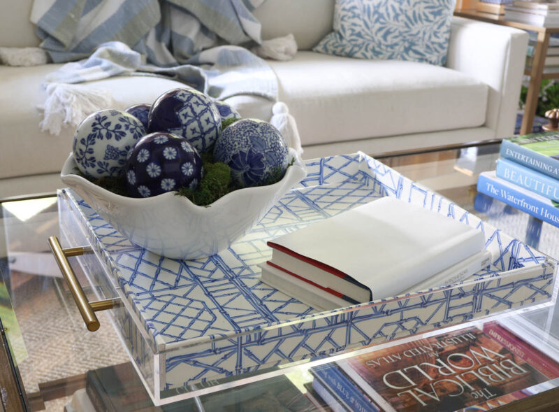 white bowl of blue ceramic balls on blue acrylic tray with white books