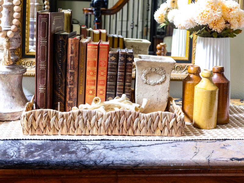 fall colored books in basket tray