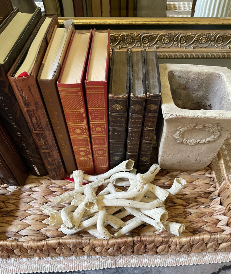 books, stone vase in a woven basket
