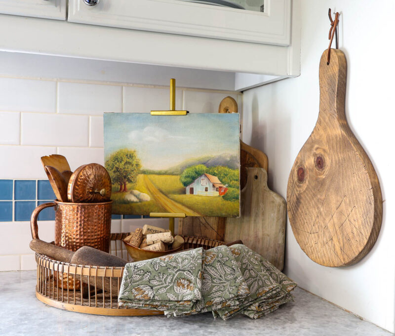 fall decor vignette with copper pitcher, napkins, bowl of wine corks