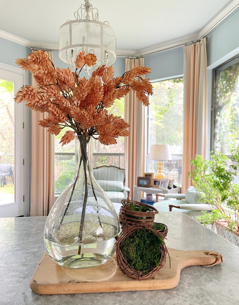 clear vase vase with faux fall stems on tray