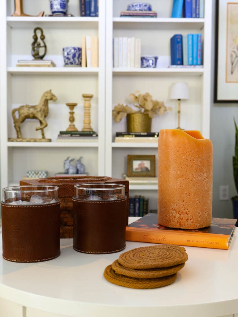 coasters on table with drinks, candle, and book