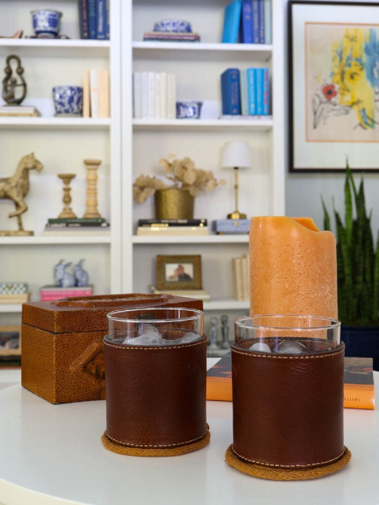 coasters on table with drinks, candle, and book