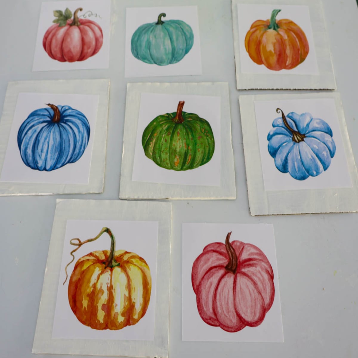 group of colorful painted pumpkins on paper