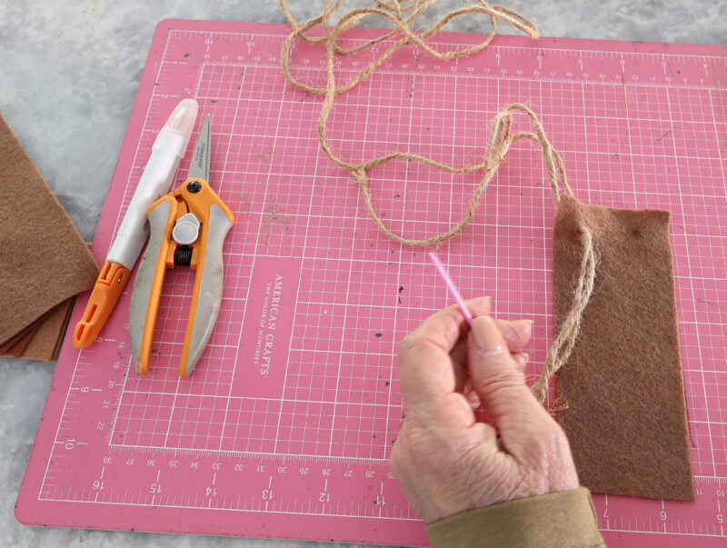 threading jute twine through the sewing needle