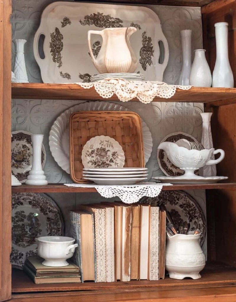 pine hutch styled for fall with brown transferware, ironstone, and pumpkins and books used on hutch