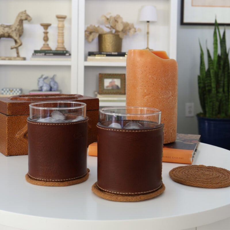 coasters on table with drinks, candle, and book feature
