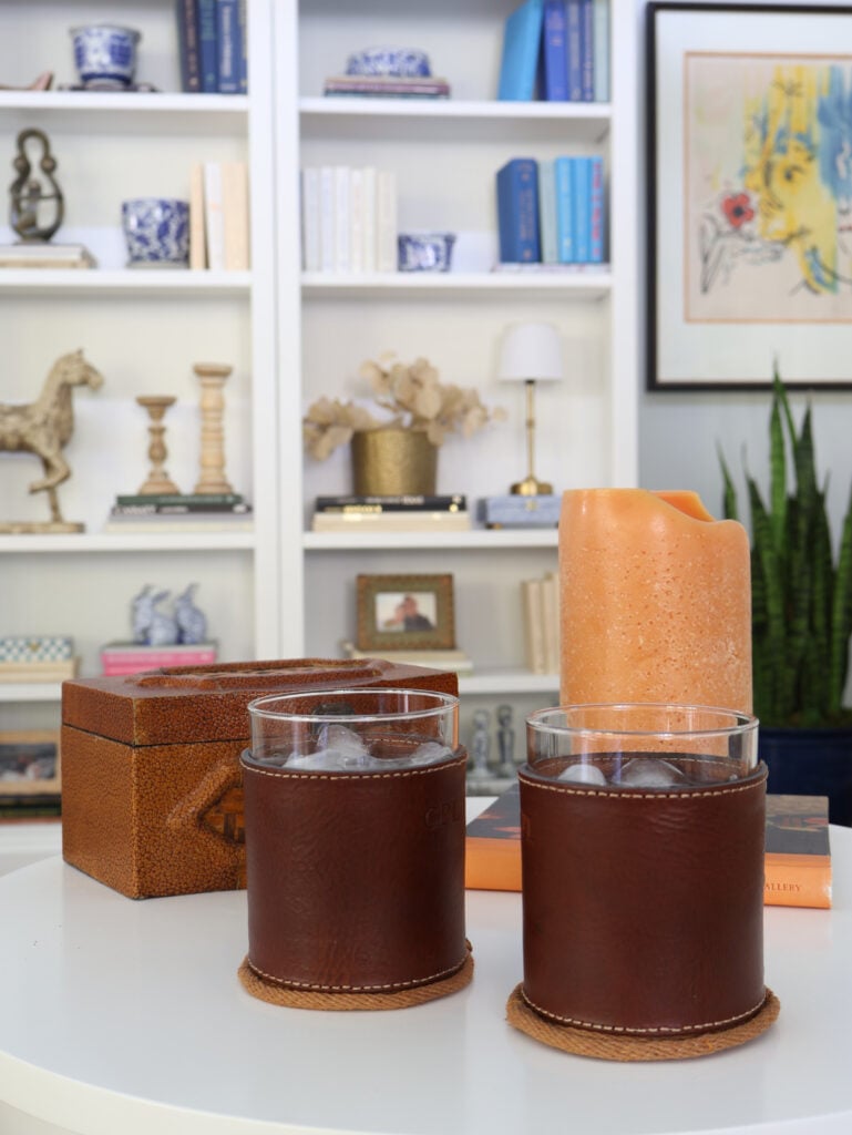 coasters on table with drinks, candle, and book