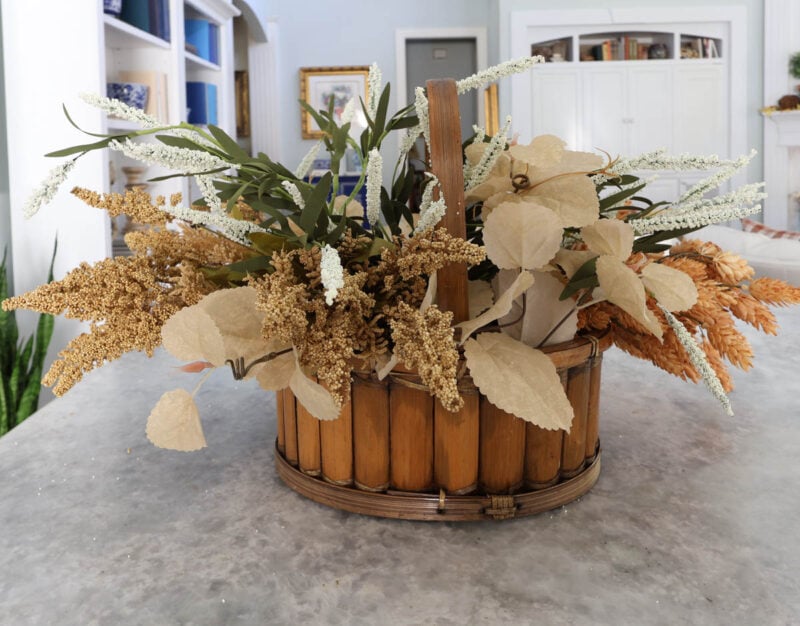 fall faux foliage in a basket with a handle