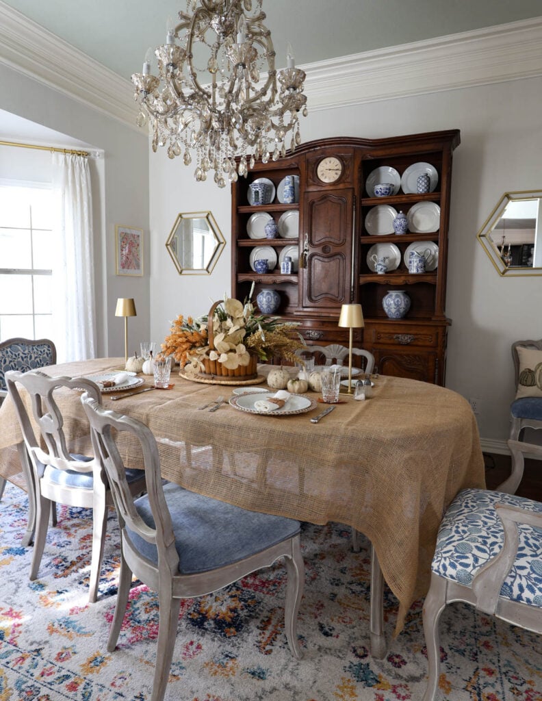 fall tablescape with basket centerpiece and gold lamps