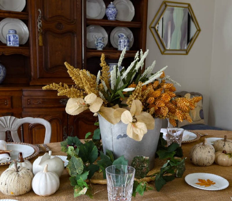 silver pail with fall flowers on tablescape