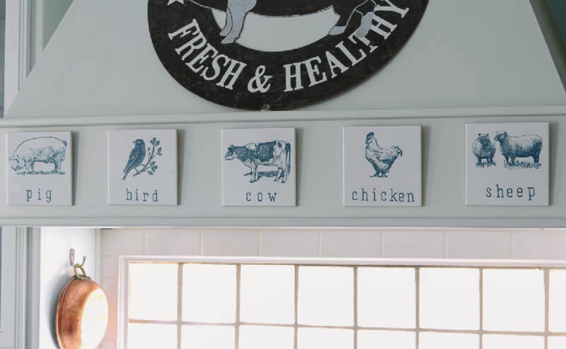 farmhouse style stenciled tiles on stovetop hood