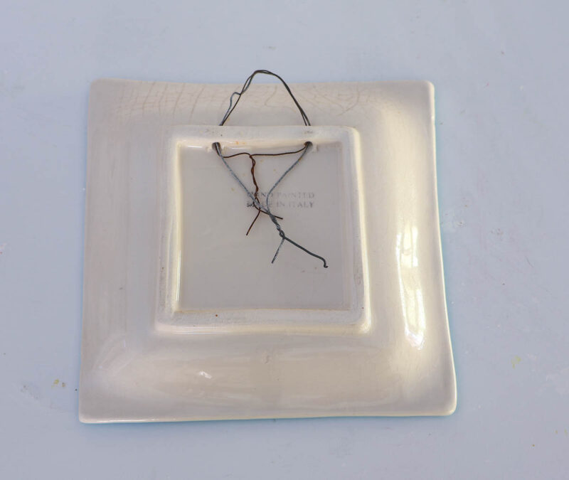 back of ceramic tile with wire hanger
