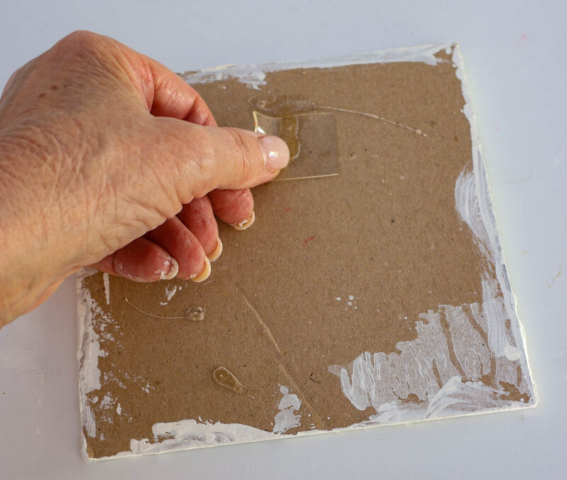 adding adhesive tape to back of cardboard