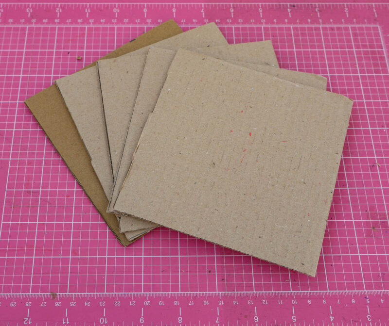5 square pieces of cardboard