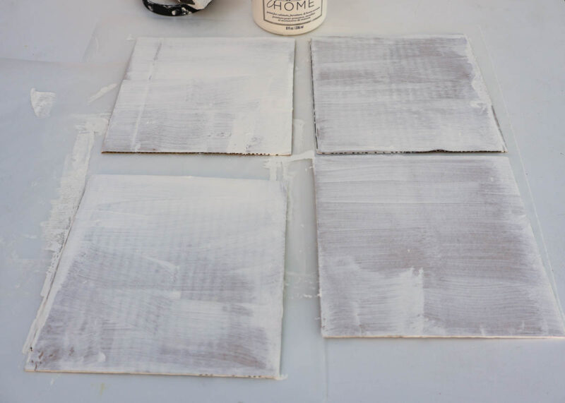 square cardboard tiles painted with white paint