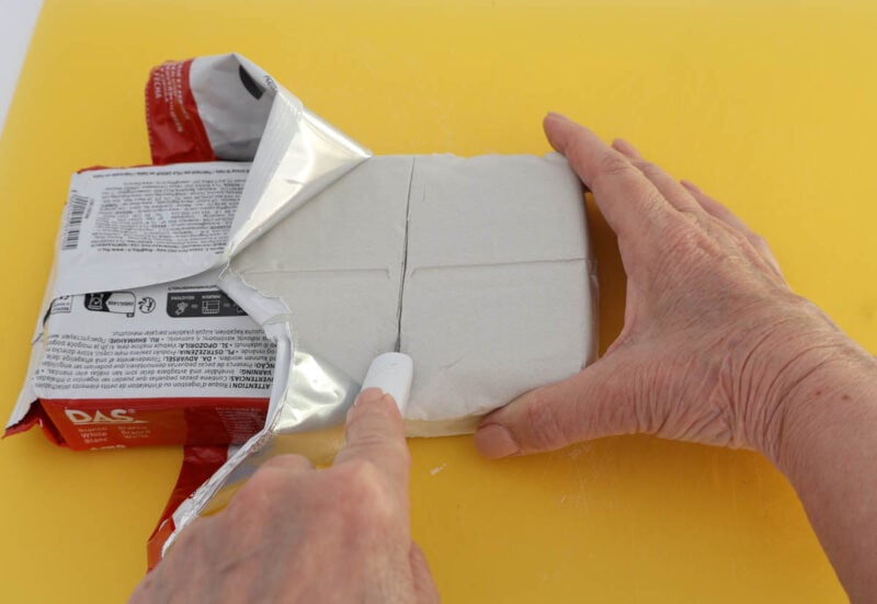 cutting piece of air-dry clay with an x-acto knife