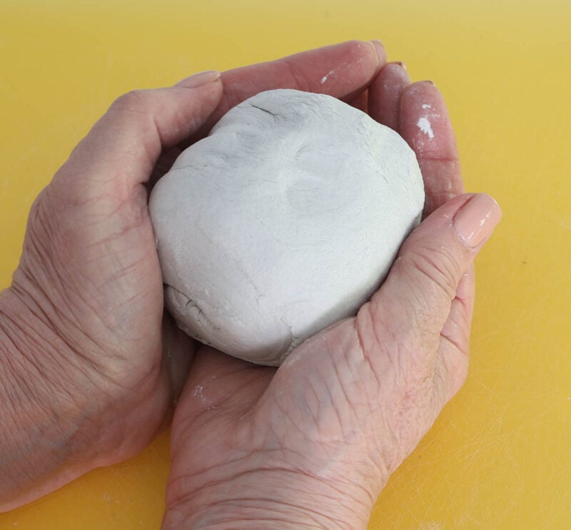 ball of air-dry clay in palm of hands