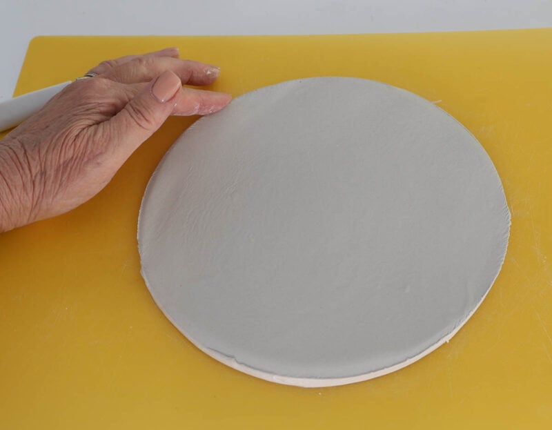 use finger to smooth rough edges of clay circle