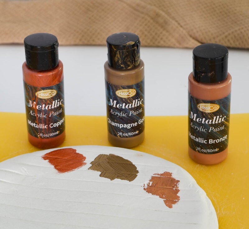 samples of three metallic paint on back of clay tray