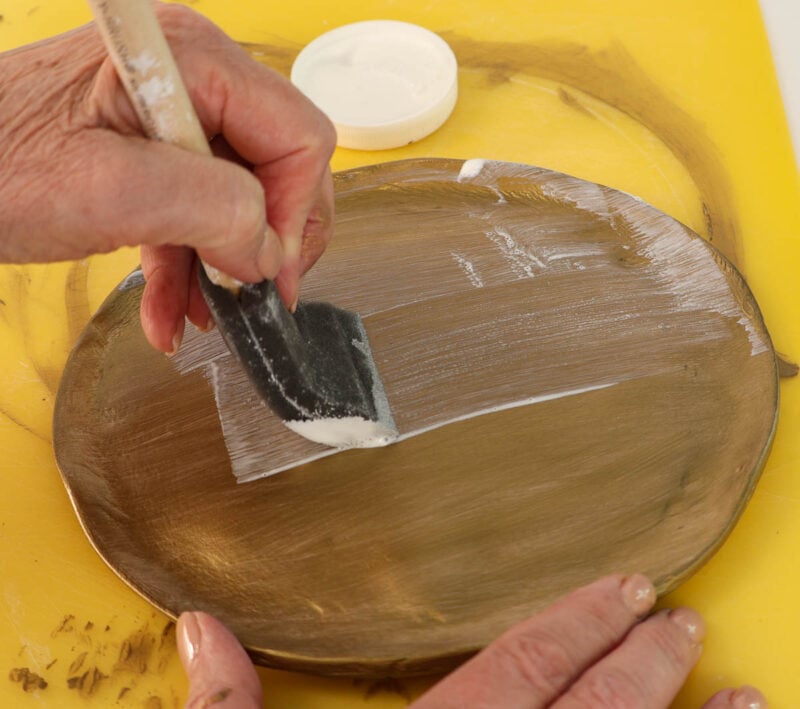 applying Mod Podge to metallic paint to tray